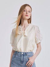 The white blouse is made from viscose fabri